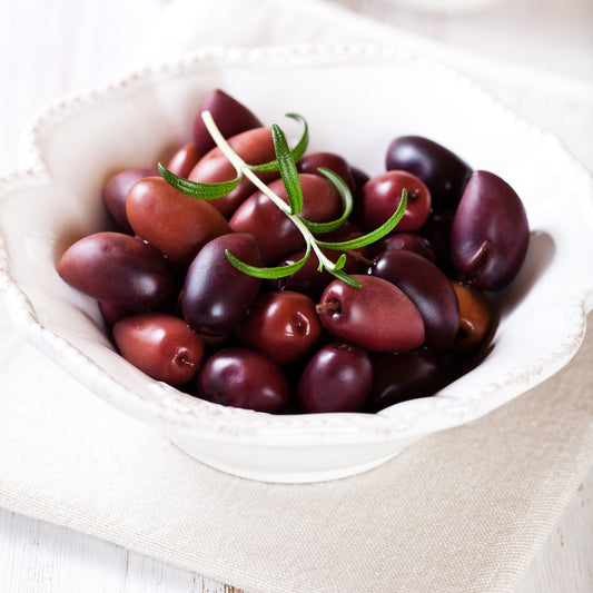 Thriving Kalamata olive trees and olive plants with silver-green leaves, producing delicious Mediterranean-style olives.